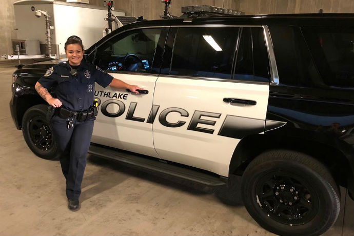 Southlake police officer Nikki Lockwood poses for a photo outside of her police cruiser.