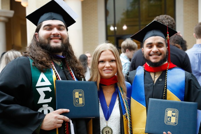Photo of three Texas Wesleyan graduates from Spring 2019 Commencement.