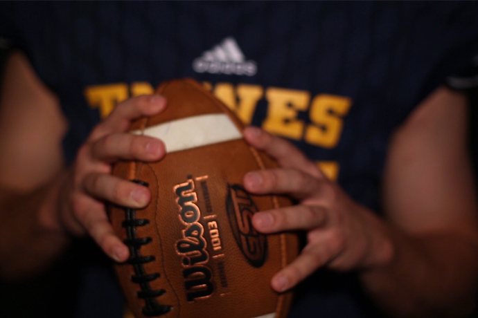 Picture is of a football held by a TXWES football player