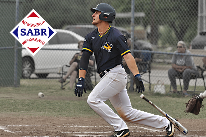 Menedez looks a the ball after he swings his bat. The SABR logo is also pictured