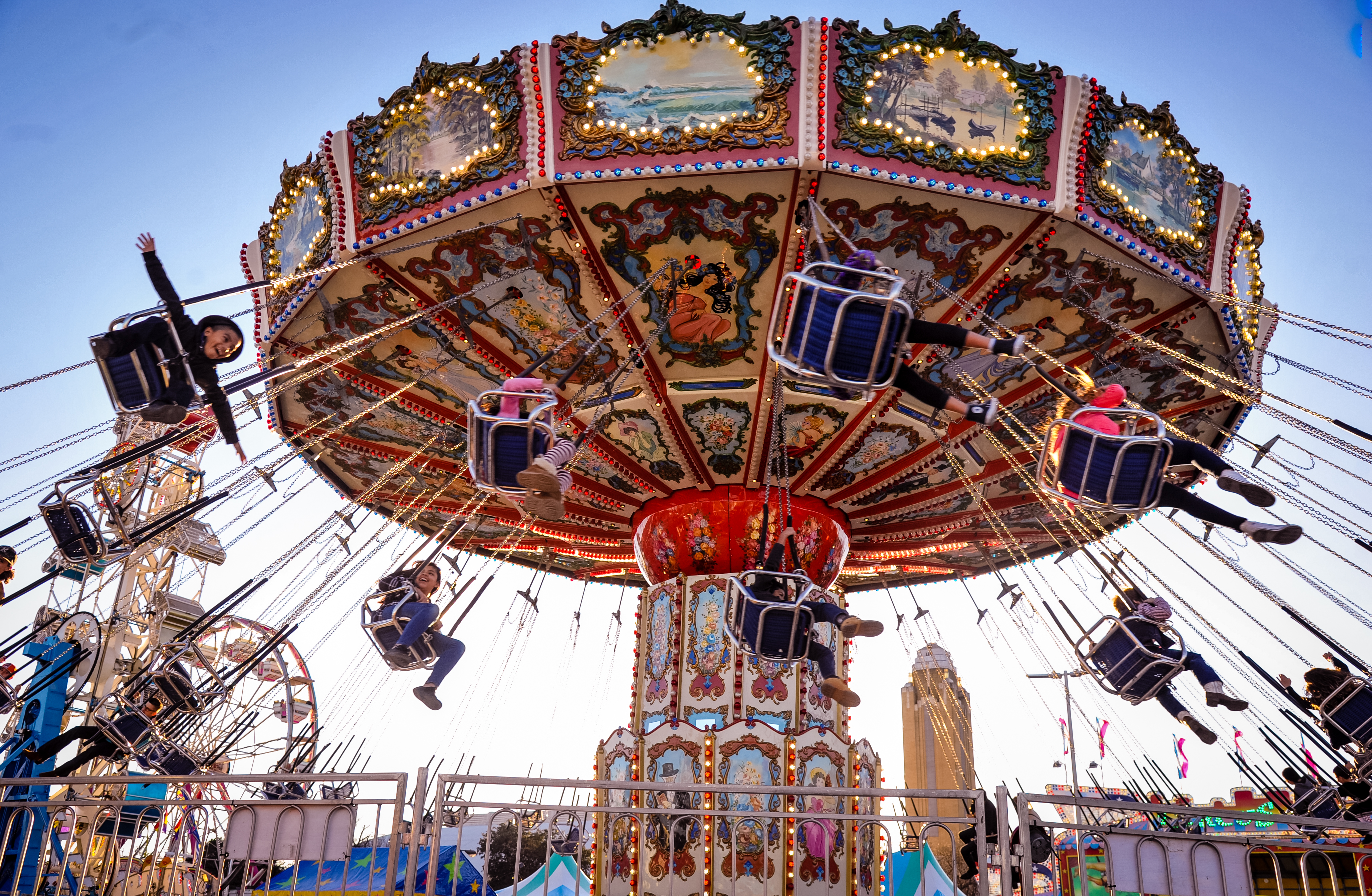 Riders swing on a rollercoaster at the rodeo