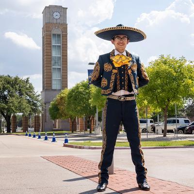 Benjamin Domenzain in traditional ballet folklorico uniform in front of the bell tower