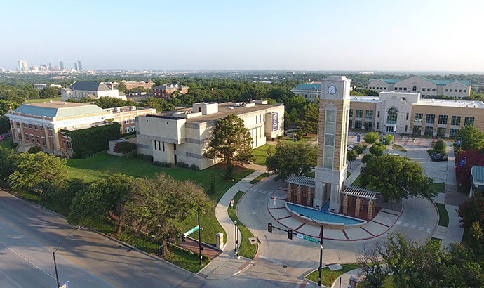 the university clocktower and campus entrance as seen from above
