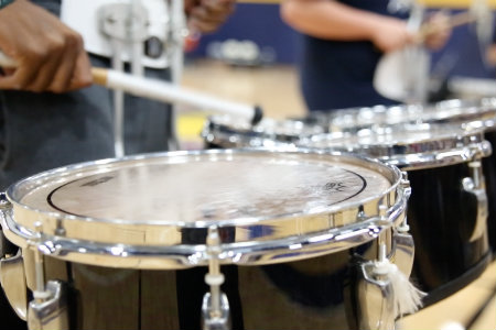 Student playing drums at basketball game