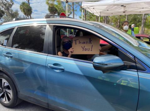 Florida resident shows sign that says 