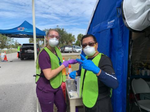 Dr. Jose Castillo poses with colleague during COVID-19 vaccination clinic