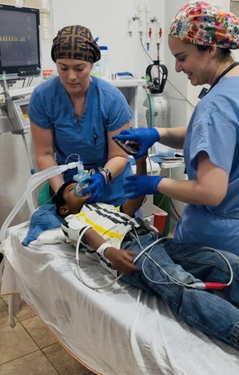 Students practicing GPNA work on a medical dummy