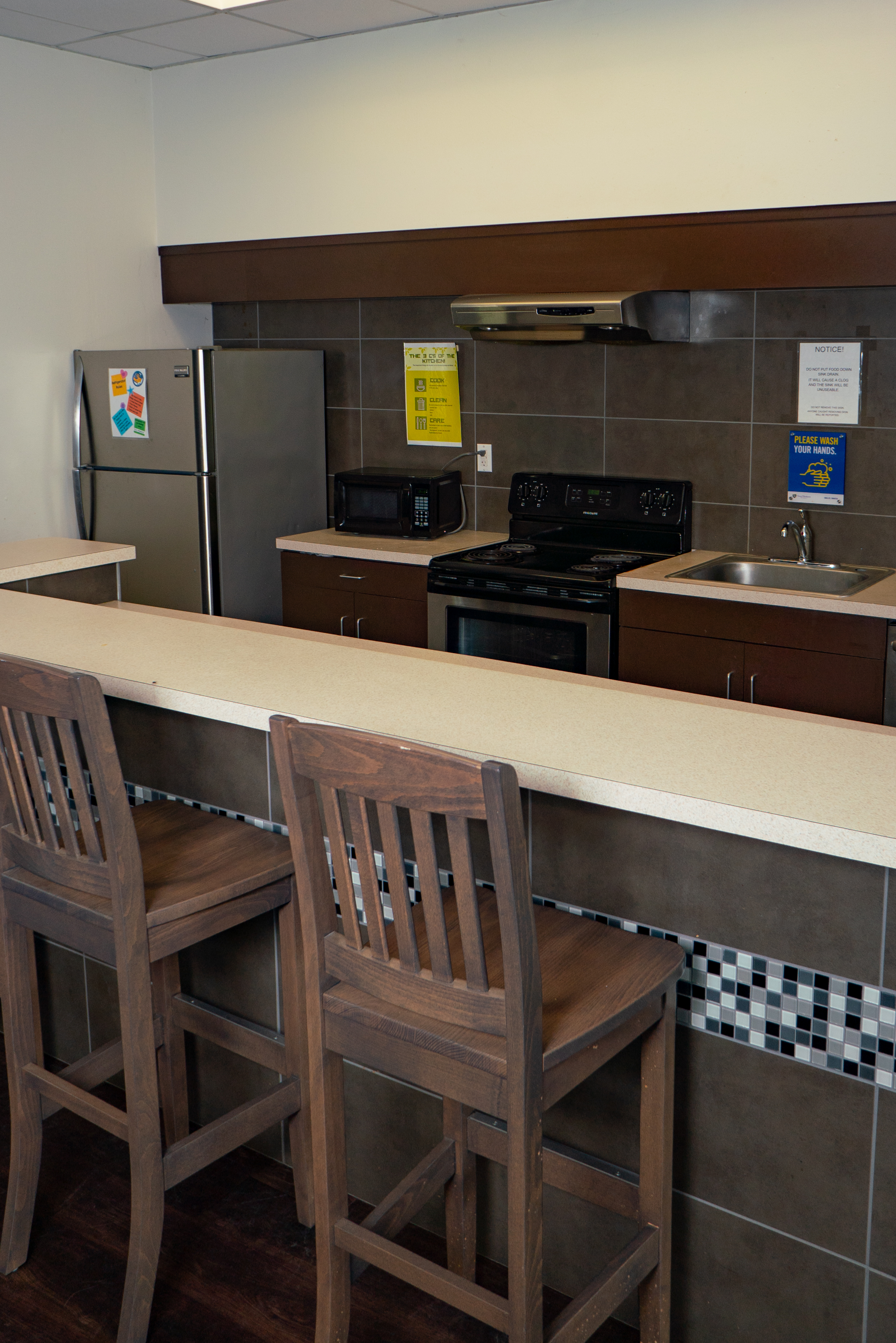 Community kitchen in Stella Hall with fridge, stove, microwave and sink