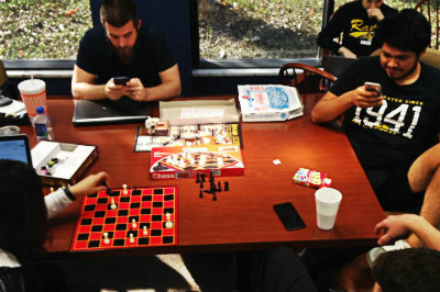 four students playing board games