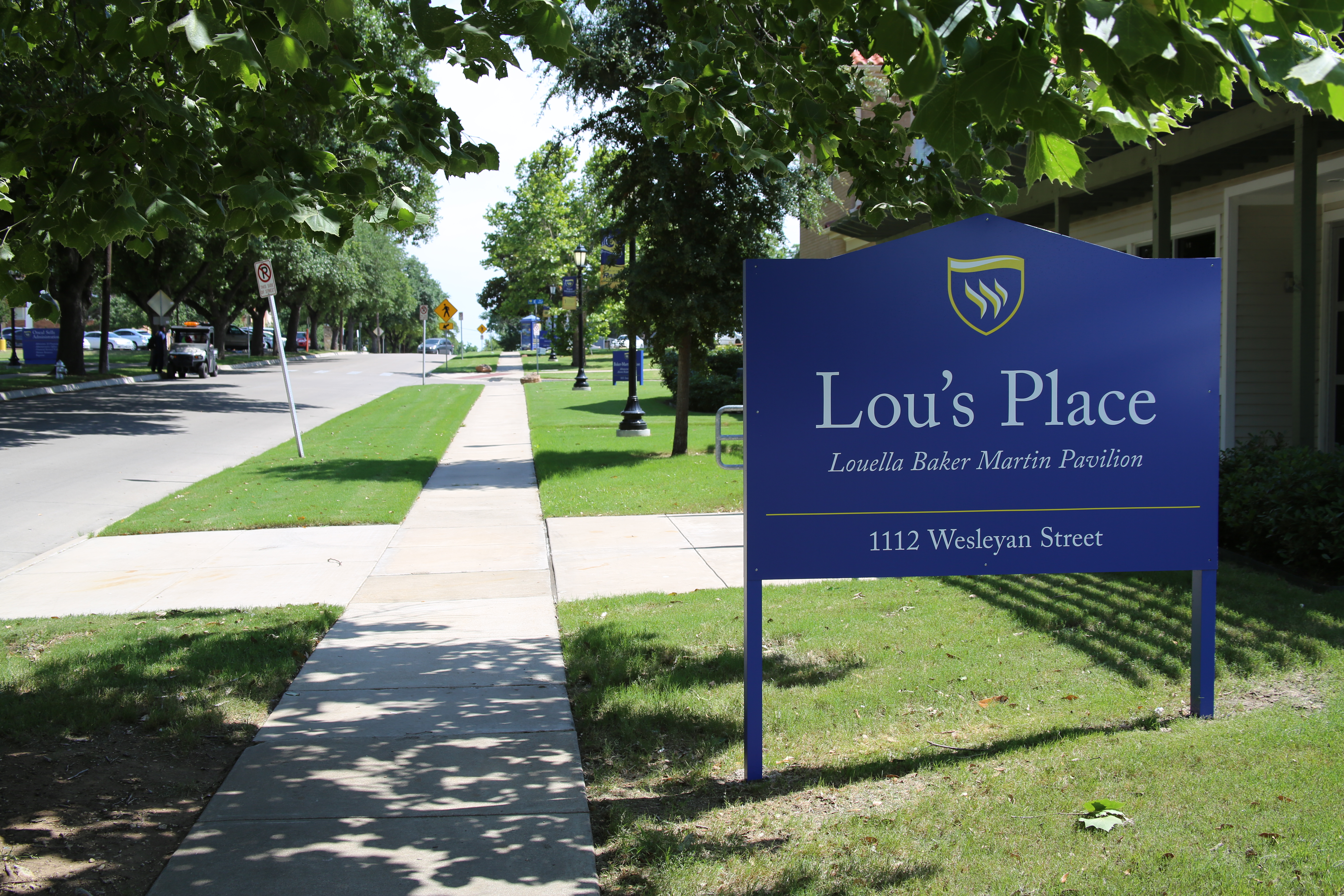 New campus sign in front of Lou's Place.