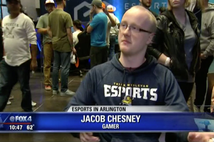 Photo of TXWES student and esports athlete Jacob Chesney being interviewed by Fox 4 during the grand opening of the city of Arlington's new esports stadium.