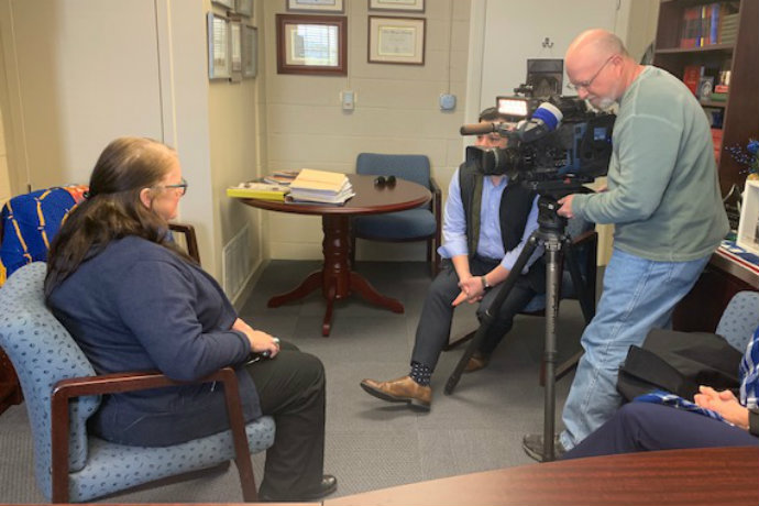 Photo of Associate Professor of Political Science Michelle Payne speaking with CBS 11 reporter Ken Molestina on a border funding proposal.