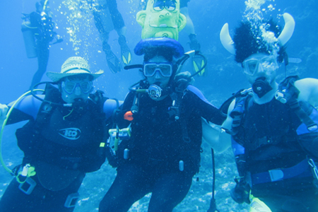 photo of three underwater divers
