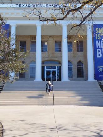 Tanner Pruitt Gottschalk Graduation Photo in Front of Admin TXWES Building