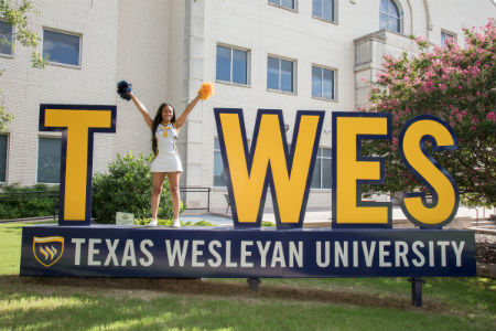 Student on TXWES Selfie Station Sign