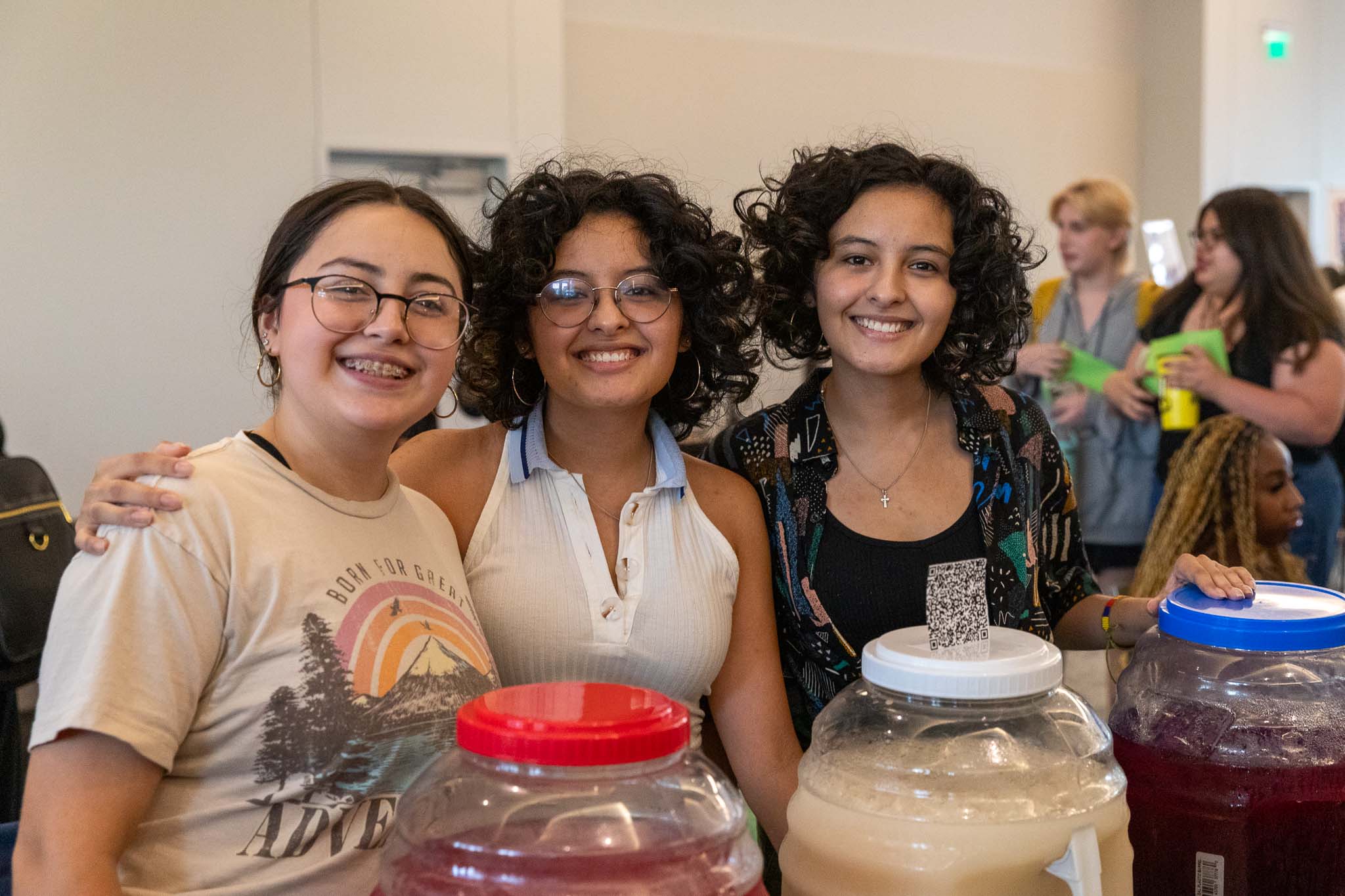 Three students in BESO smile and pose for a picture