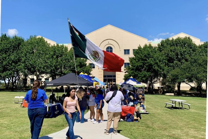 Students celebrating Hispanic Heritage Month and waving the flag