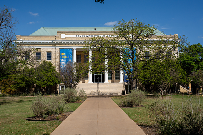 A sidewalk leading to the front of the Oneal-Sells Administration Building on the campus of Texas Wesleyan Univerasity