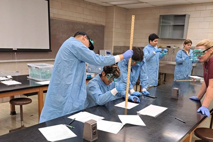 Upward Bound students work together on a project in a lab