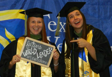 Two students celebrating on their graduation day.
