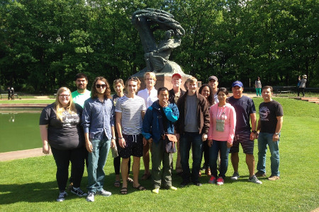 Seventeen Ethics & the Arts in Eastern Europe faculty and students at the Frederic Chopin Monument in Warsaw