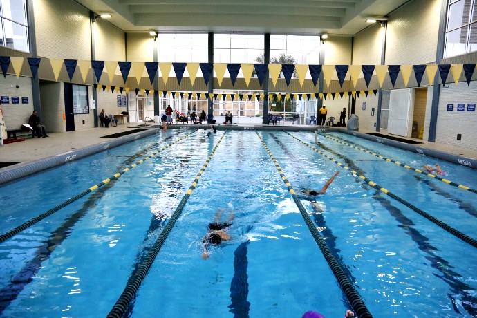 Interior of Texas Wesleyan's on-campus pool with people swimming laps