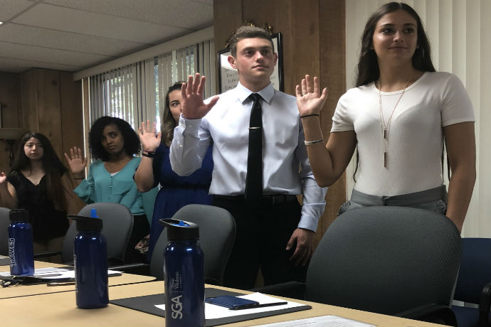 Students being sworn in to office with SGA
