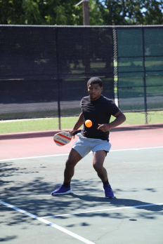 A male student playing pickleball