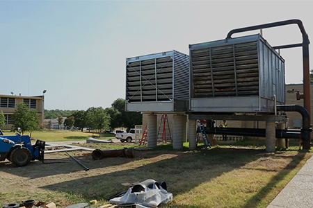 On the left is Texas Wesleyan University's new cooling tower, next to the existing cooling tower. Both cooling towers will support the new energy-saving power plant.