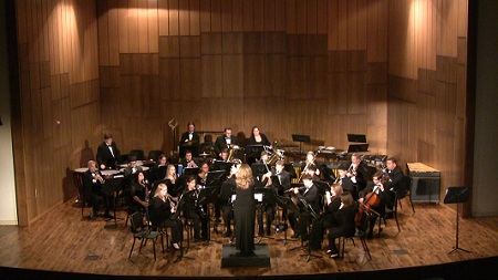 The wind ensemble performs a concert