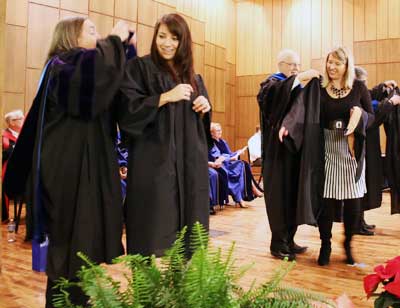 Students get their graduation robes at the December 2014 robing ceremony.